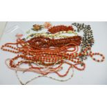 A collection of beaded jewellery including coral