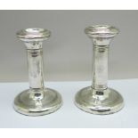 A pair of silver candlesticks, Birmingham 1909, 10.5cm, a/f