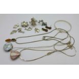 A silver pendant and matching earrings, a silver bracelet, two silver pendants and chains and