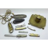 A brass inkwell and a collection of Army and other pocket knives