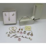 Nine pairs of silver earrings, six silver charms and a matching necklace, bracelet and earrings