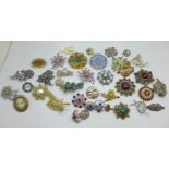 Thirty-five brooches, including two silver, some with missing stones