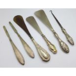 Six silver handled items including two shoe horns