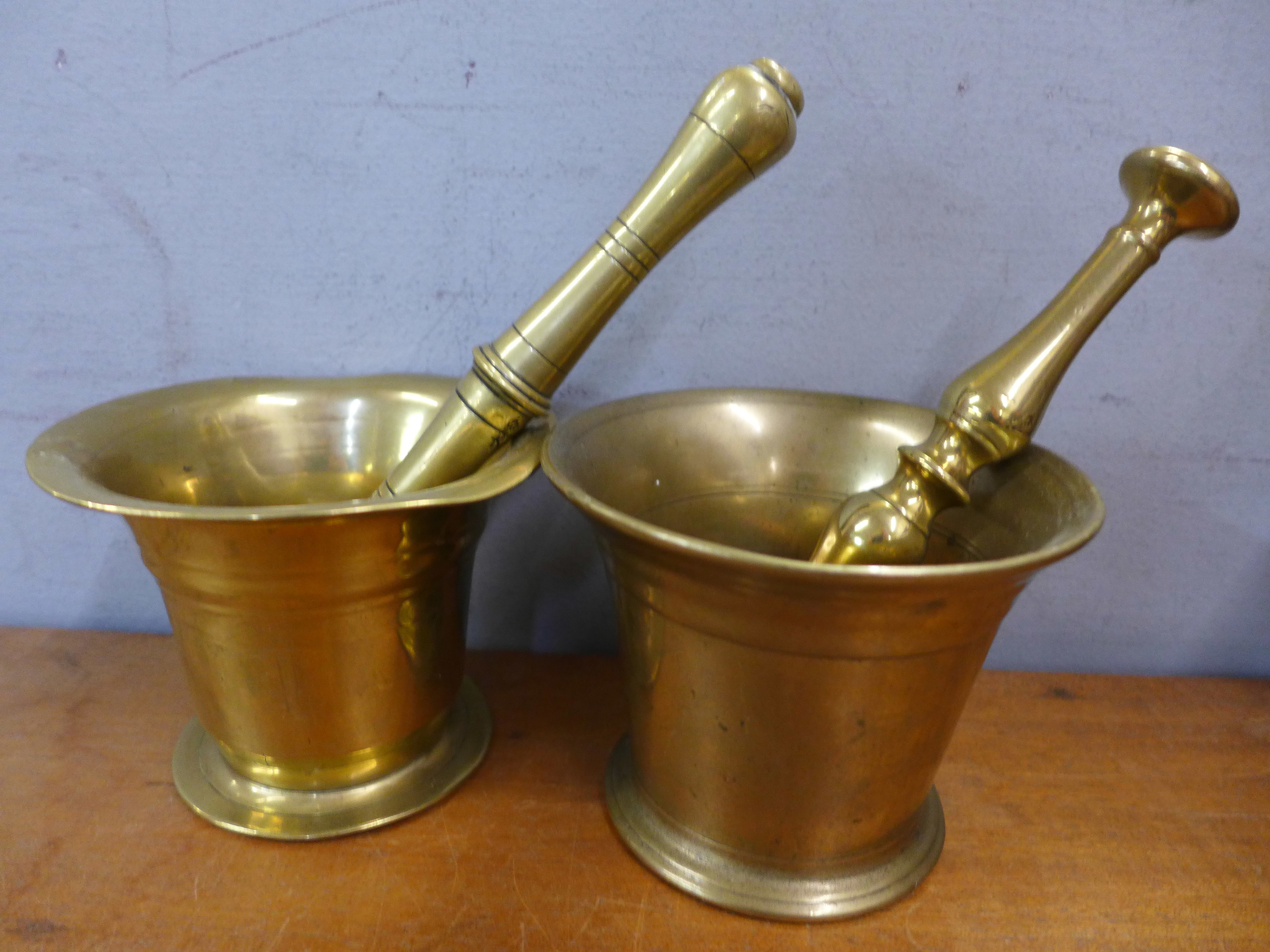 Two brass pestles and mortars