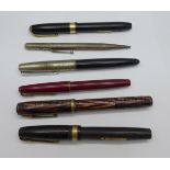 Five ink pens, two with 14k gold nibs and a Mabie Todd pencil