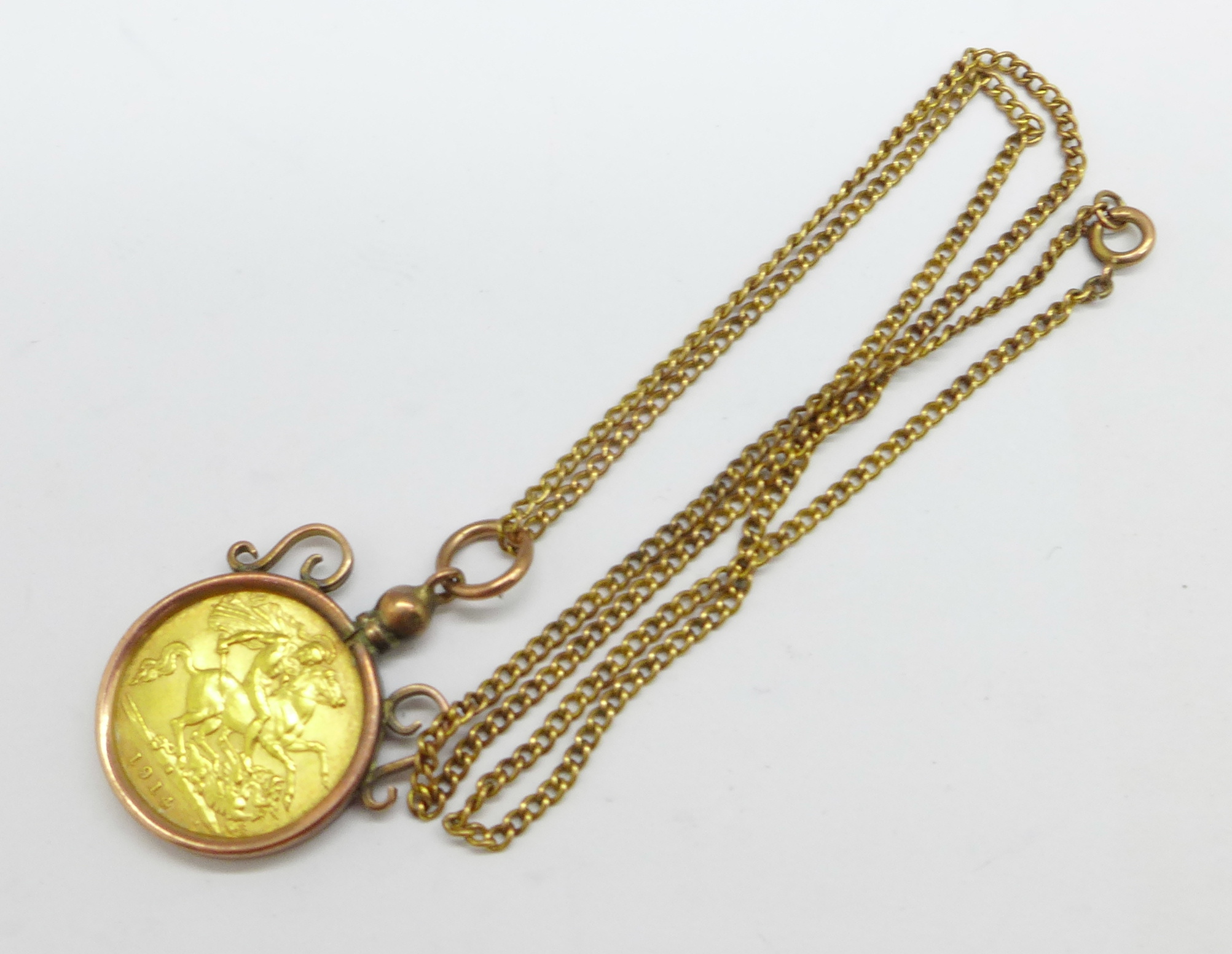 A 1914 half sovereign in a 9ct gold mount, total weight 8.8g