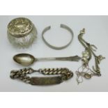 A collection of silver and white metal items including a silver topped pot, spoon and bangle and two