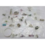 Twenty-five pairs of silver earrings