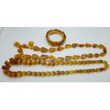 Two amber coloured bead necklaces and a bracelet