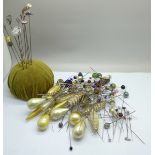 A pin cushion with nine silver hat pins including Charles Horner and other hat pins