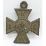 A cast metal cross with skull and crossbones, 10cm