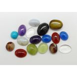 A collection of loose gemstones including moonstone, tiger's eye, turquoise, etc.