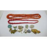 Two bead necklaces and a collection of brooches