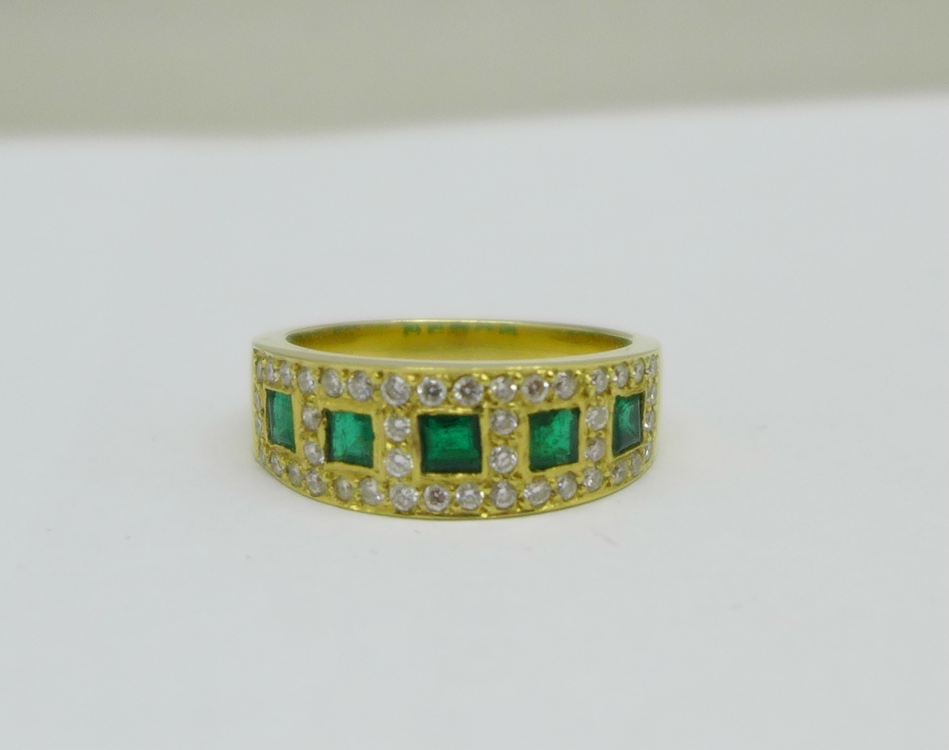 A yellow metal, emerald and diamond ring, marked 750 in the shank, 6.1g, O