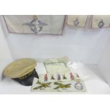 A collection of needlework and embroideries including military themed and a sailor's cap