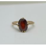 A yellow metal (tests as 9ct gold) and garnet ring, 2.0g, L