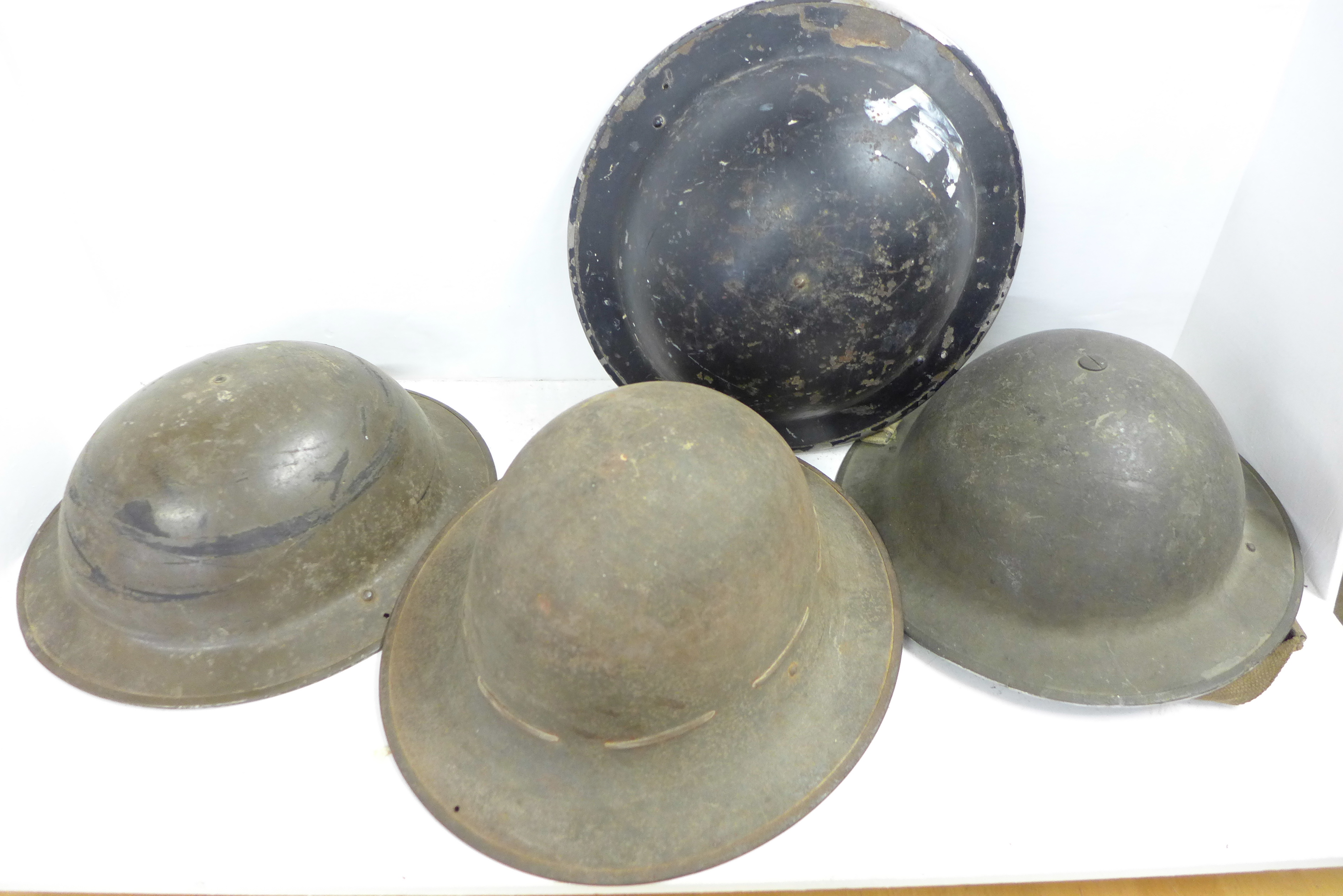 Four British WWII helmets including one civilian and an Army Officer's Regulation tunic