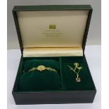 A lady's 9ct gold wristwatch, 9.6g gross including movement, and 9ct gold pendant and chain, set