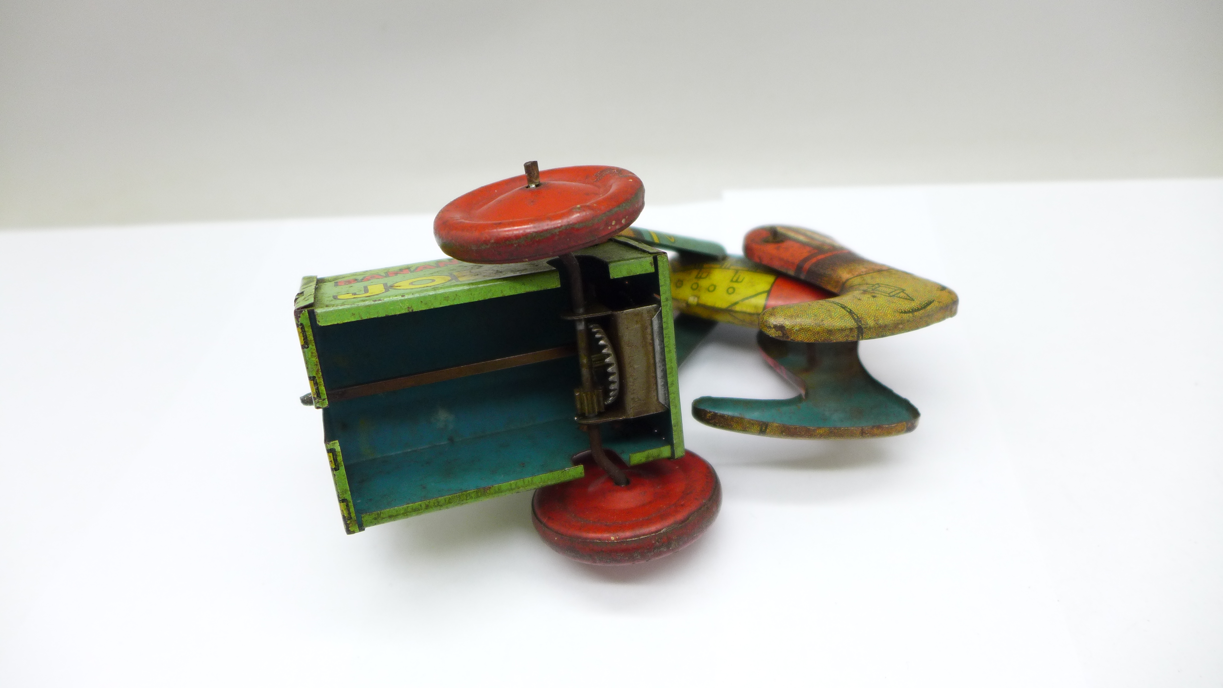 A vintage tin-plate clockwork toy monkey on a cart, marked made in England - Image 3 of 3