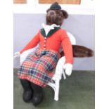 A hunting fox soft toy doll on a painted wicker chair