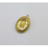 A yellow metal locket, tests as gold, 1.8g