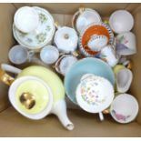 A yellow bone china tea set comprising six cups, six saucers, a milk jug, sugar bowl and tea pot,