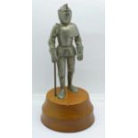 A metal Knight table lighter on a wooden base