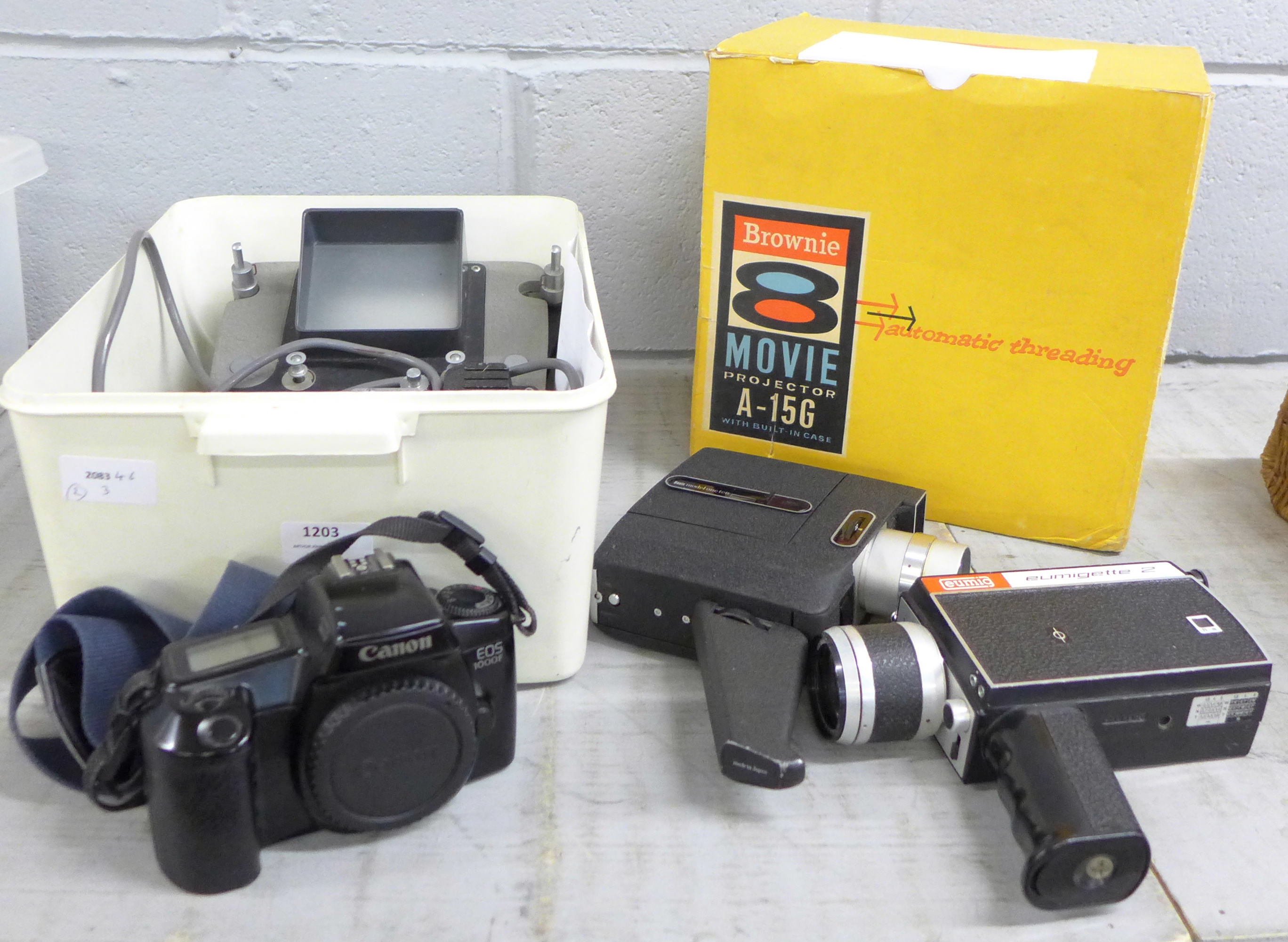 A Brownie 8 movie projector, boxed and other camera equipment including a slide editor, two movie