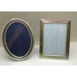 An oval silver photograph frame and a rectangular silver plated photograph frame