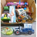 A collection of tin-plate toys, Tri-ang cabin cruiser, locomotive, etc.