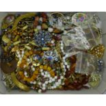 A collection of costume jewellery including brooches, beaded necklaces, earrings, etc.