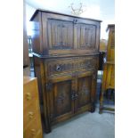 A carved oak linenfold cocktail cabinet