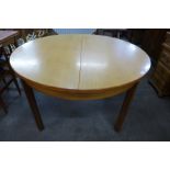 A teak extending dining table