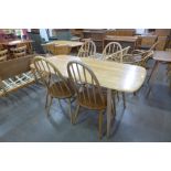 An Ercol Blonde elm and beech plank dining table and four Quaker chairs