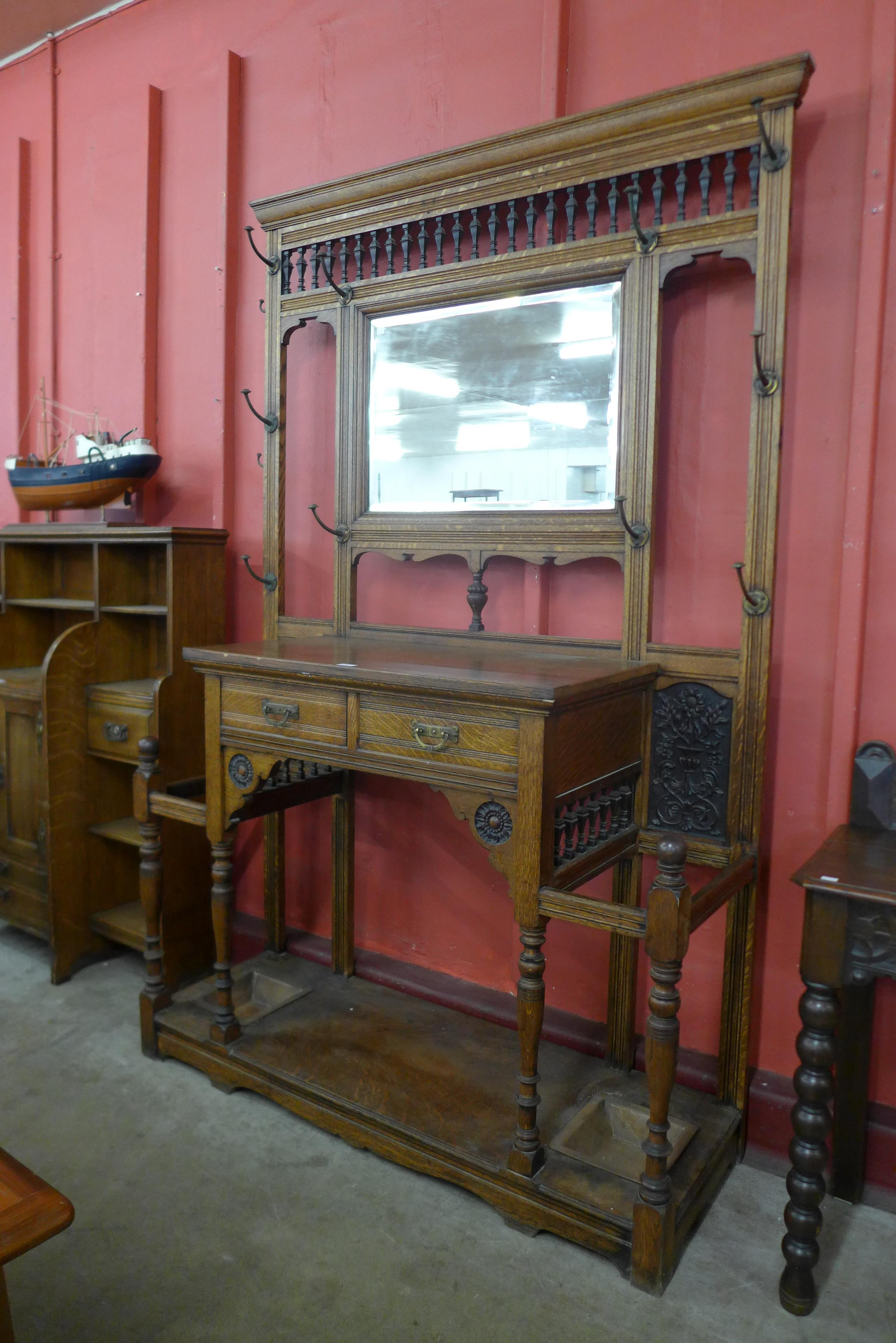 A large Victorian Aesthetic Movement carved oak hallstand