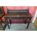 A Victorian Jacobean Revival carved oak single drawer hall table