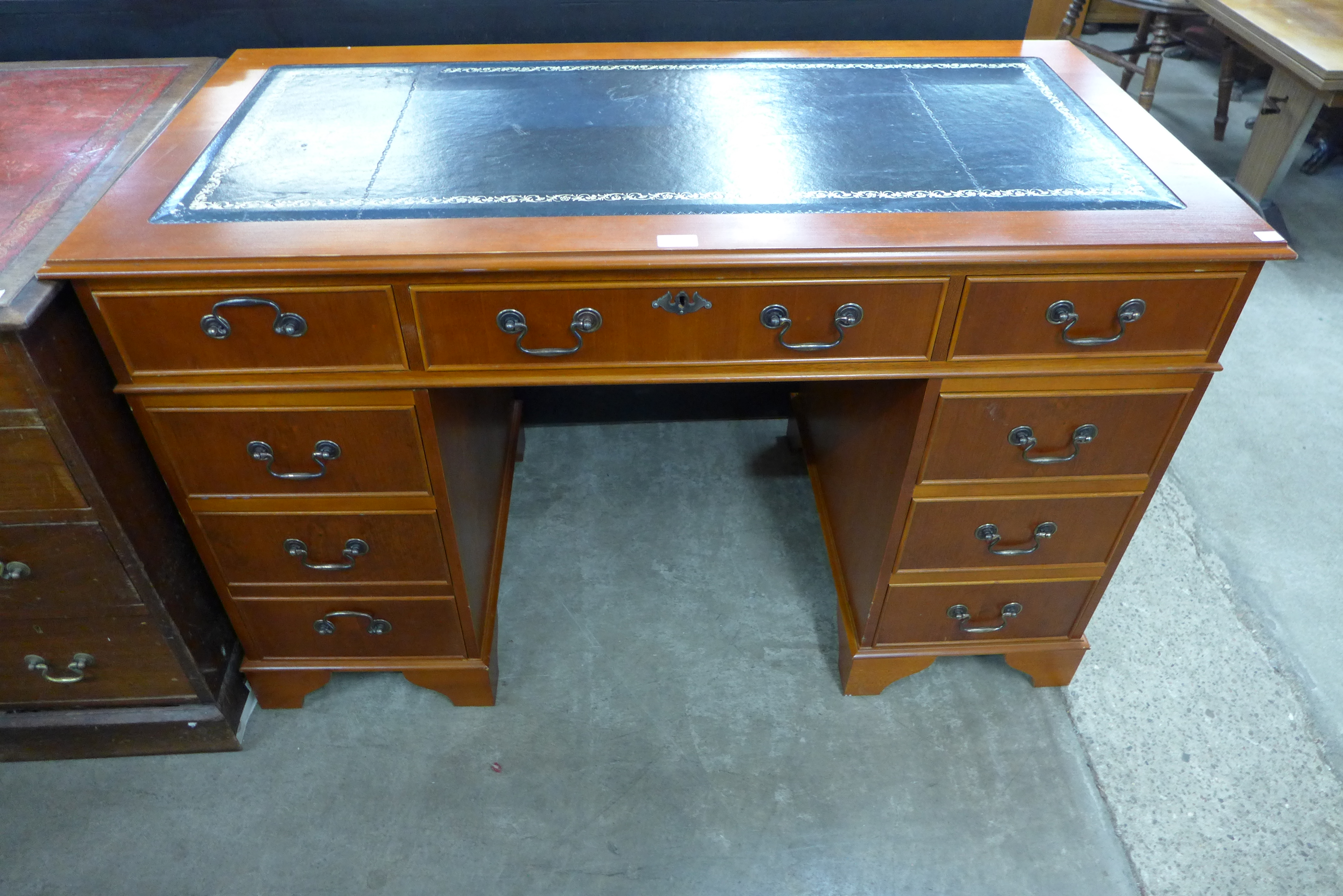 A Yew wood and leather topped desk