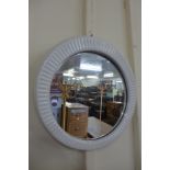 A mid 20th Century white ceramic framed circular mirror