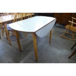 A Kandya Gingham pattern Formica and beech drop-leaf table, designed by Frank Guille