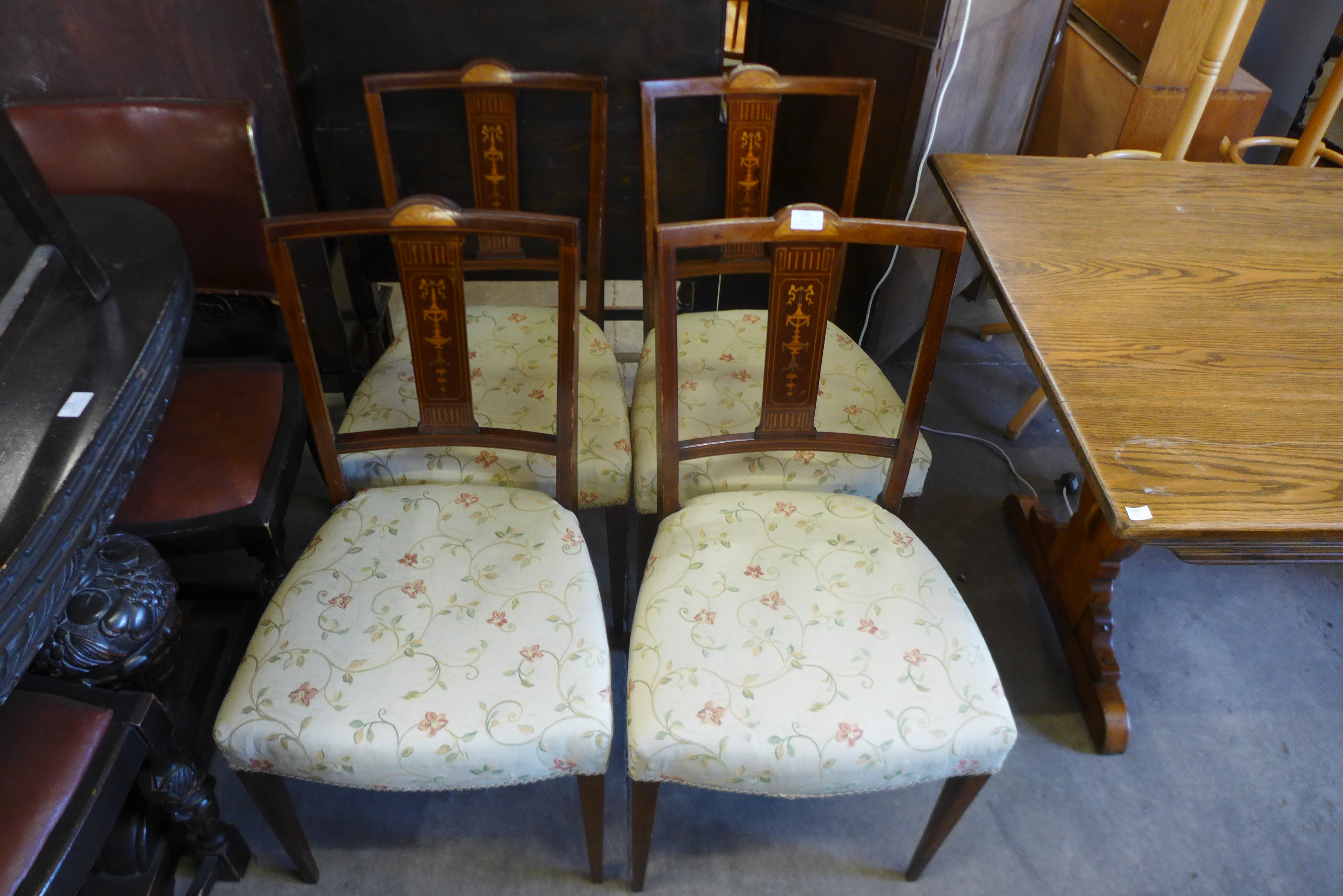 A set of four Edward VII inlaid mahogany chairs