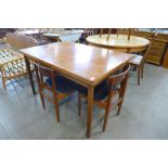 A teak extending dining table and four chairs