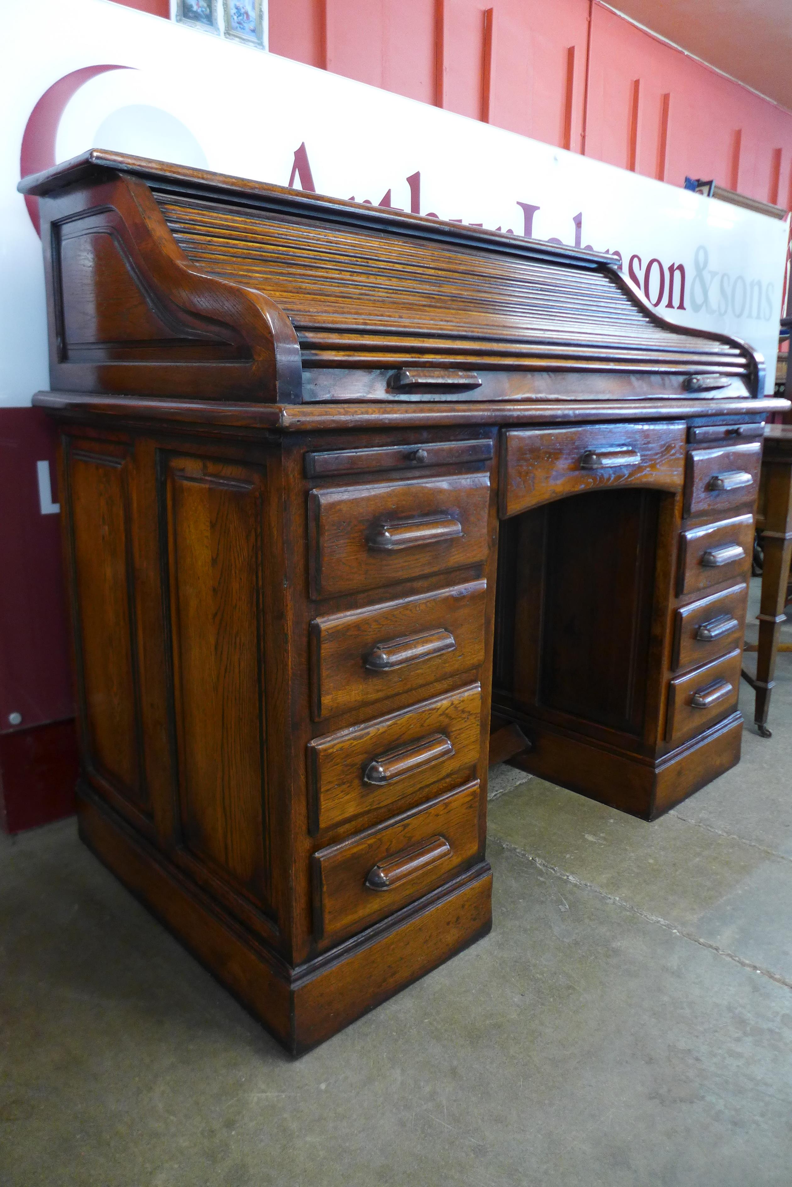 An oak tambour roll top desk