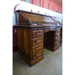 An oak tambour roll top desk