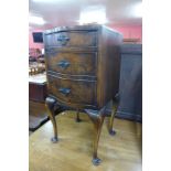 A burr walnut serpentine pot cupboard