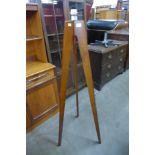 A teak tripod standard lamp