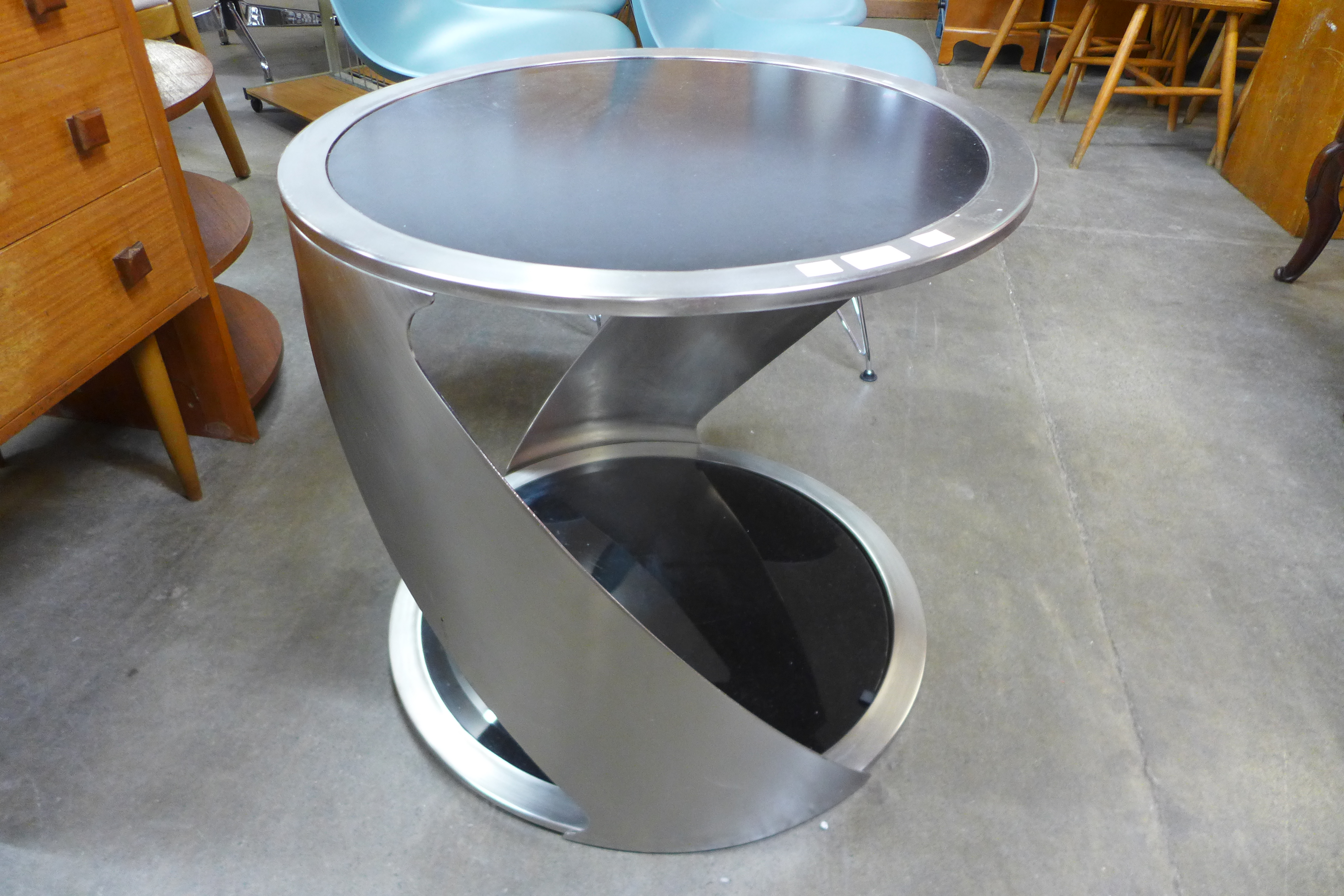 A chrome and black glass circular two tier coffee table