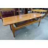 A teak concave ended coffee table