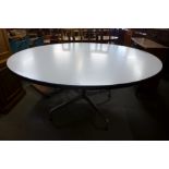 A Charles & Ray Eames chrome and white laminated circular Vitra dining table