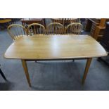 An Ercol Golden Dawn elm and beech plank dining table