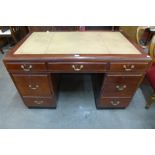 A mahogany and leather topped library desk